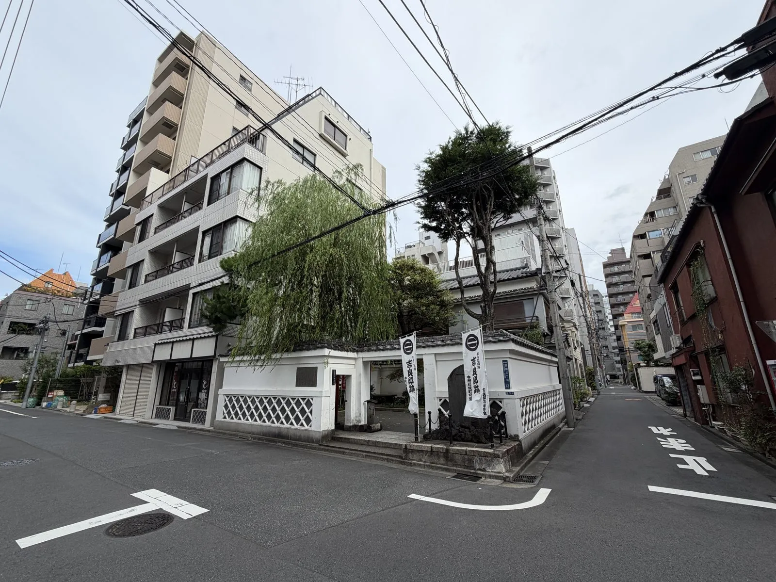 交差点の角、ビルと住宅に挟まれて、なまこ壁に囲まれた小さな一角が立つ